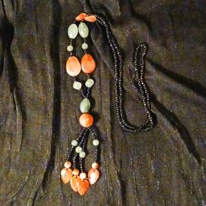 Black beaded necklace wl green, reddish orange and cream swirl with orange beads